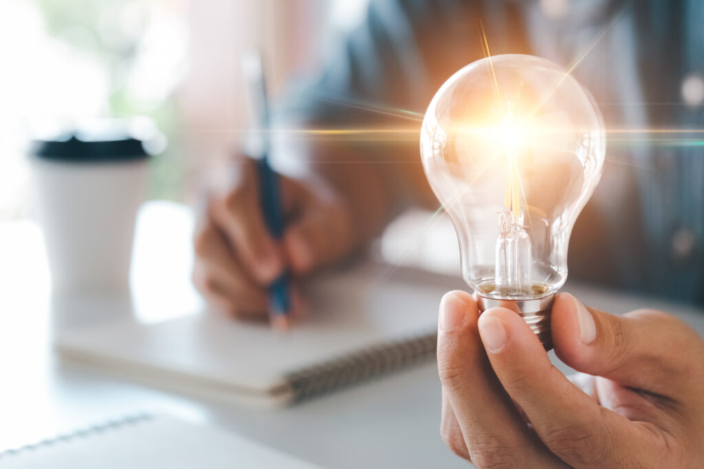 Innovation through ideas and inspiration ideas. Human hand holding light bulb to illuminate, idea of creativity and inspiration concept of sustainable business development. Innovation through ideas and inspiration ideas. Human hand holding light bulb to illuminate, idea of creativity and inspiration concept of sustainable business development.